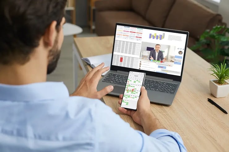 A sales person at a laptop with a calendar, focused on appointment setting.